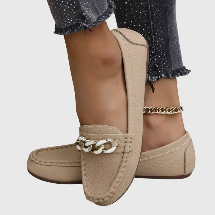 Beige chain loafers with gold-tone chain bracelet and braided top detail