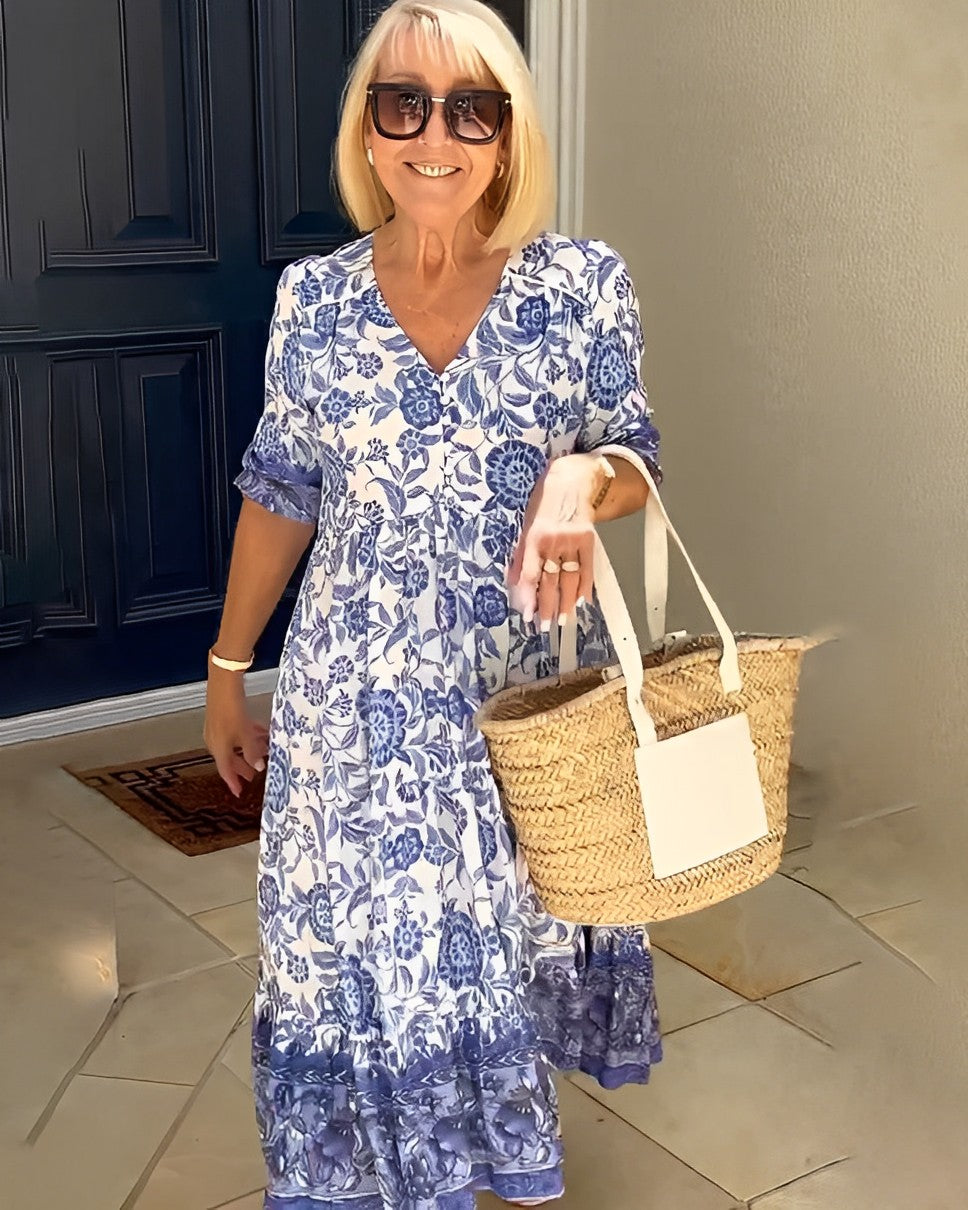 Blue floral V-neck midi dress with short sleeves, ruffled hem, and front gathers