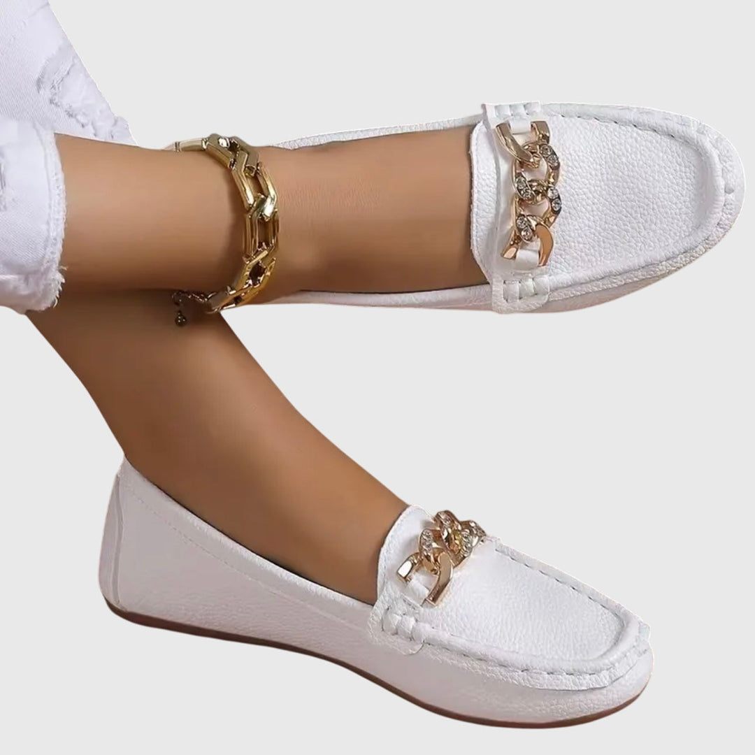 White chain loafers with gold-tone hardware and rounded moc-toe stitching