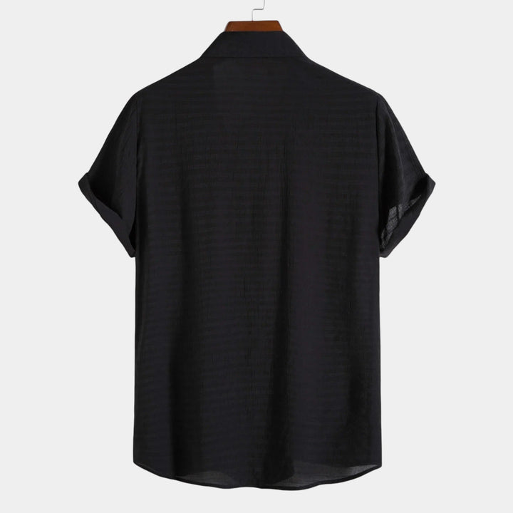 Dark short-sleeve summer shirt, back view with curved hem