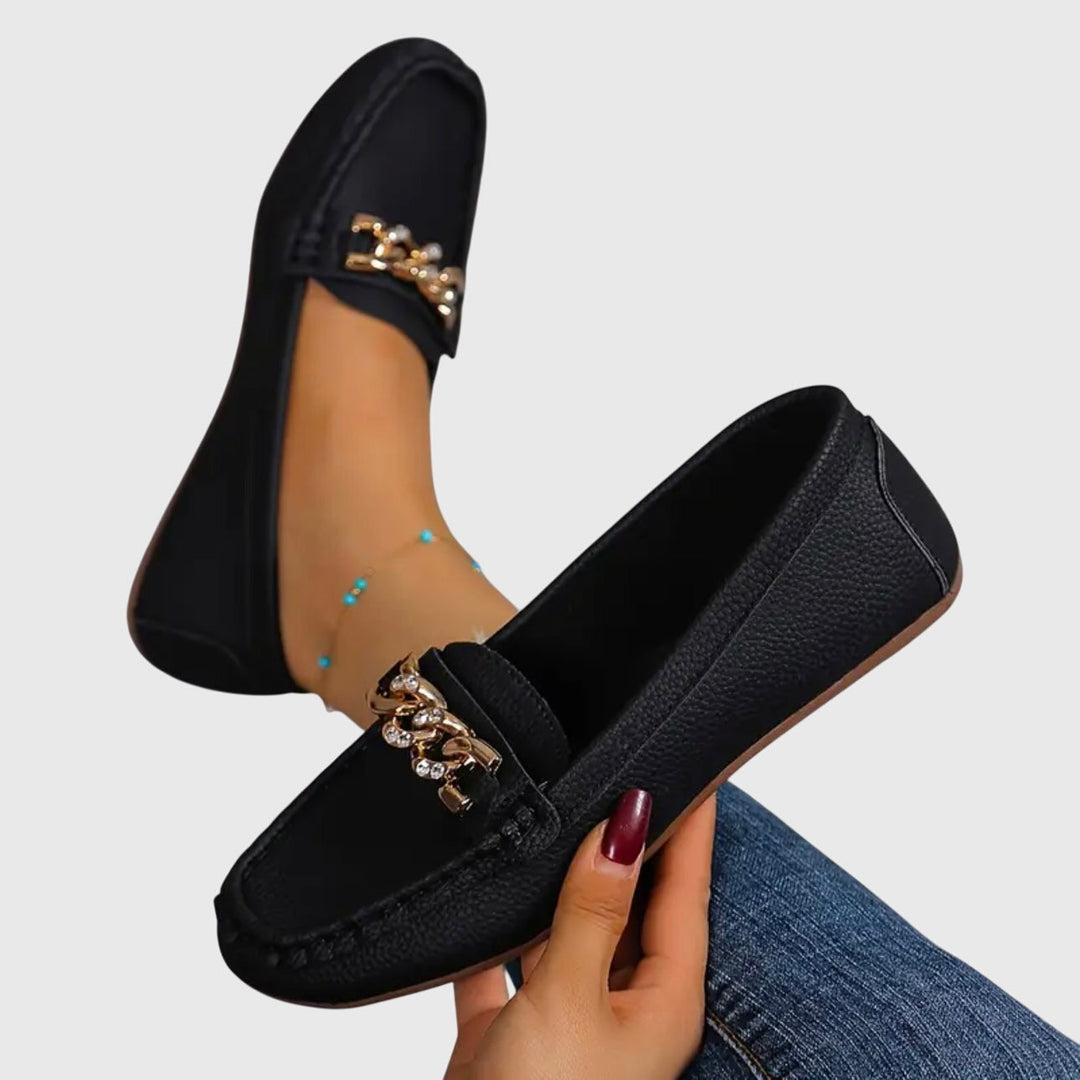 Black chain loafers with gold-tone chain detail on the front strap