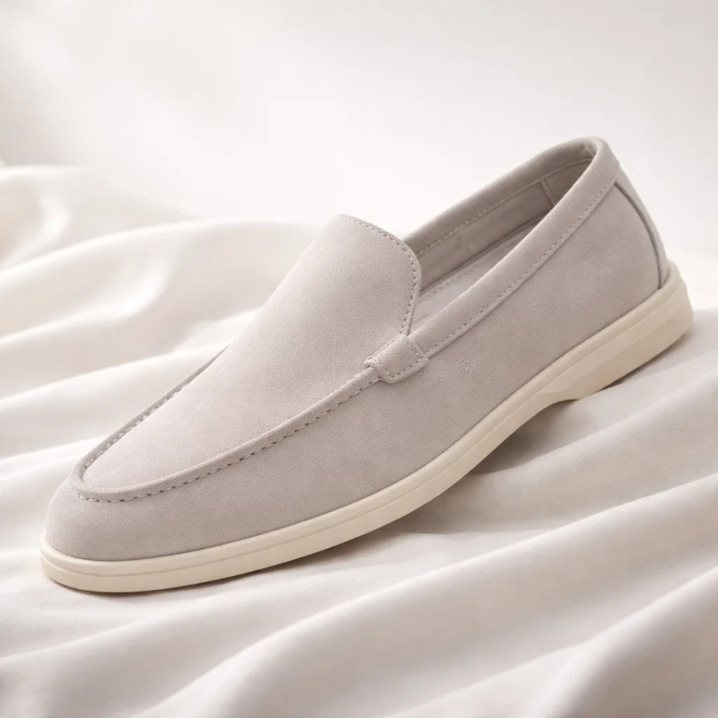Light gray suede loafer with stitched penny collar and white rubber sole