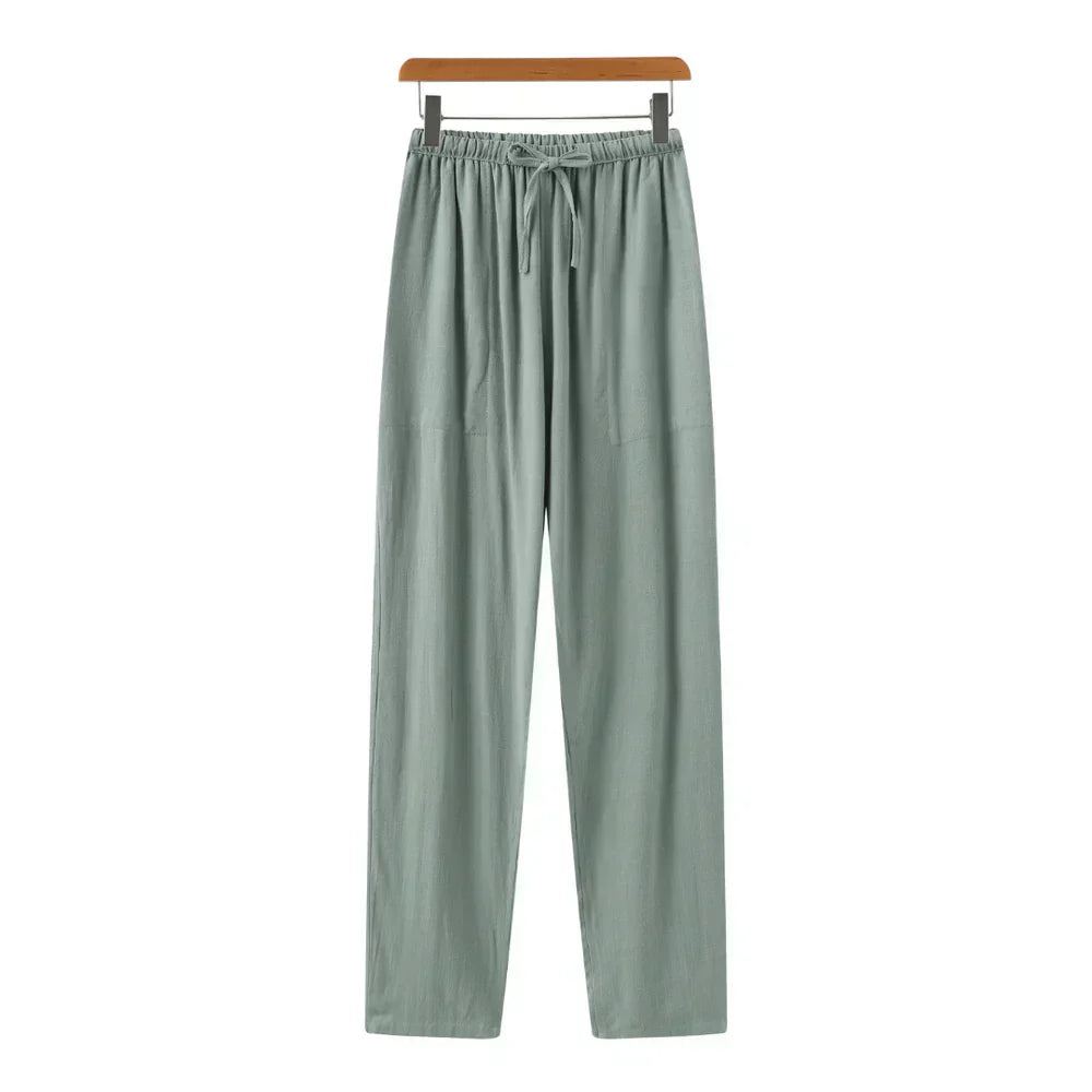 Green linen pants with elastic waistband, drawstring, and relaxed straight legs.