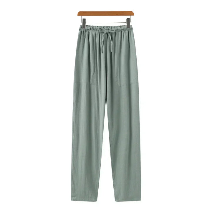 Green linen pants with elastic waistband, drawstring, and relaxed straight legs.