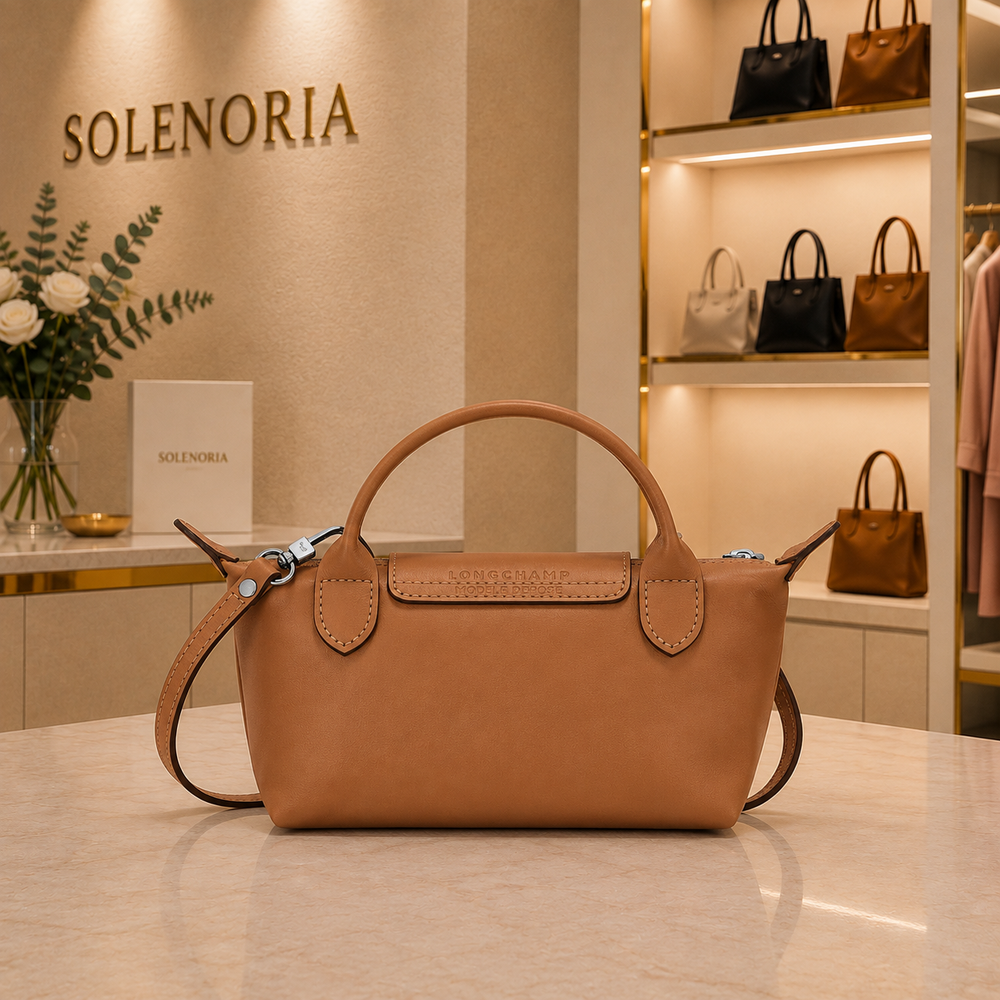 Mini brown leather tote bag with top handles and front logo patch