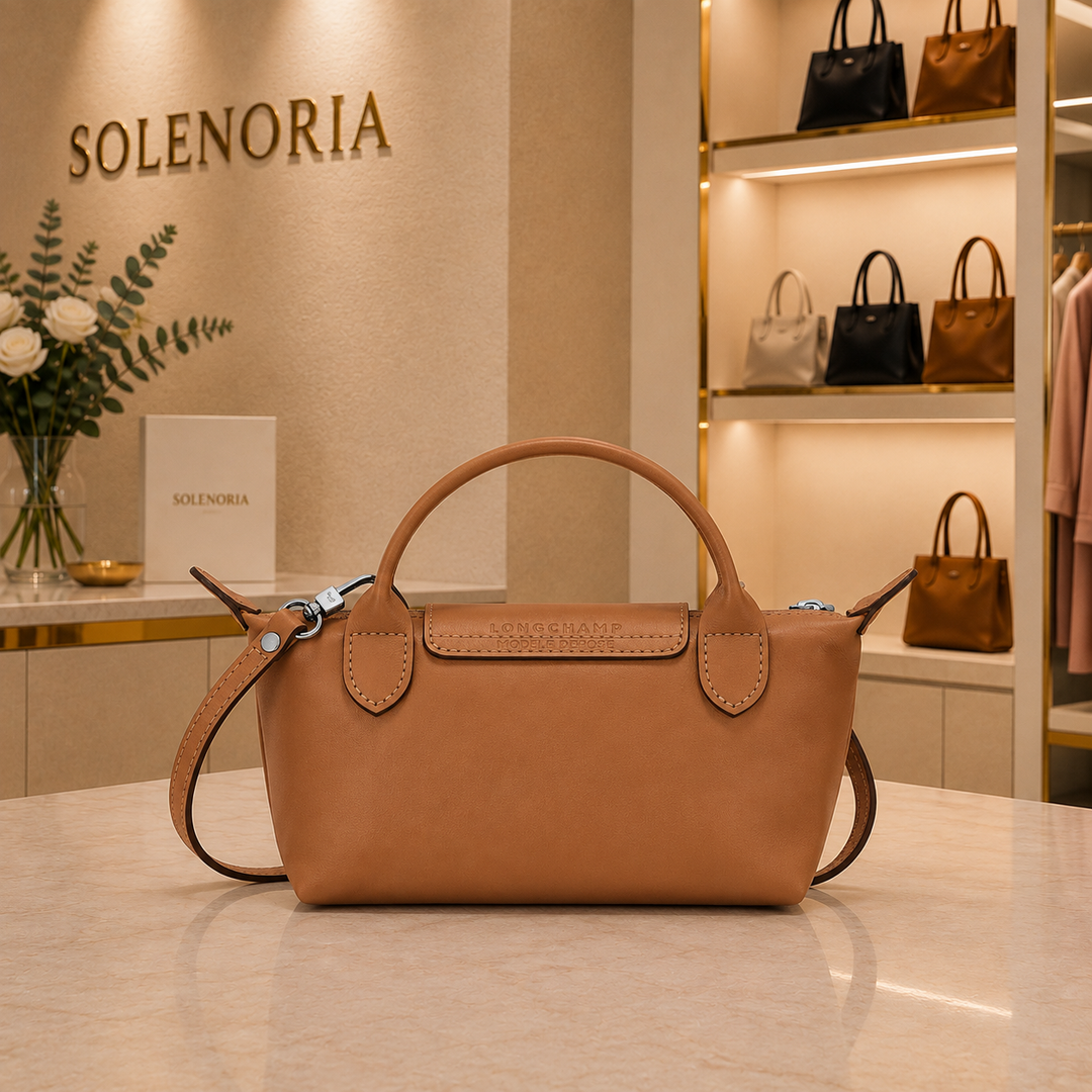 Mini brown leather tote bag with top handles and front logo patch