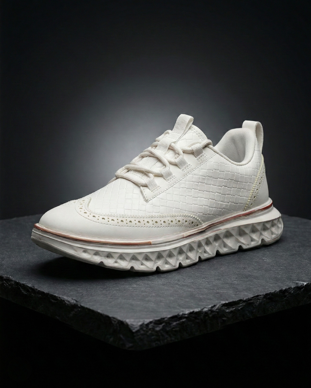 White dress sneaker with woven texture, lace-up front, and thick white tread sole