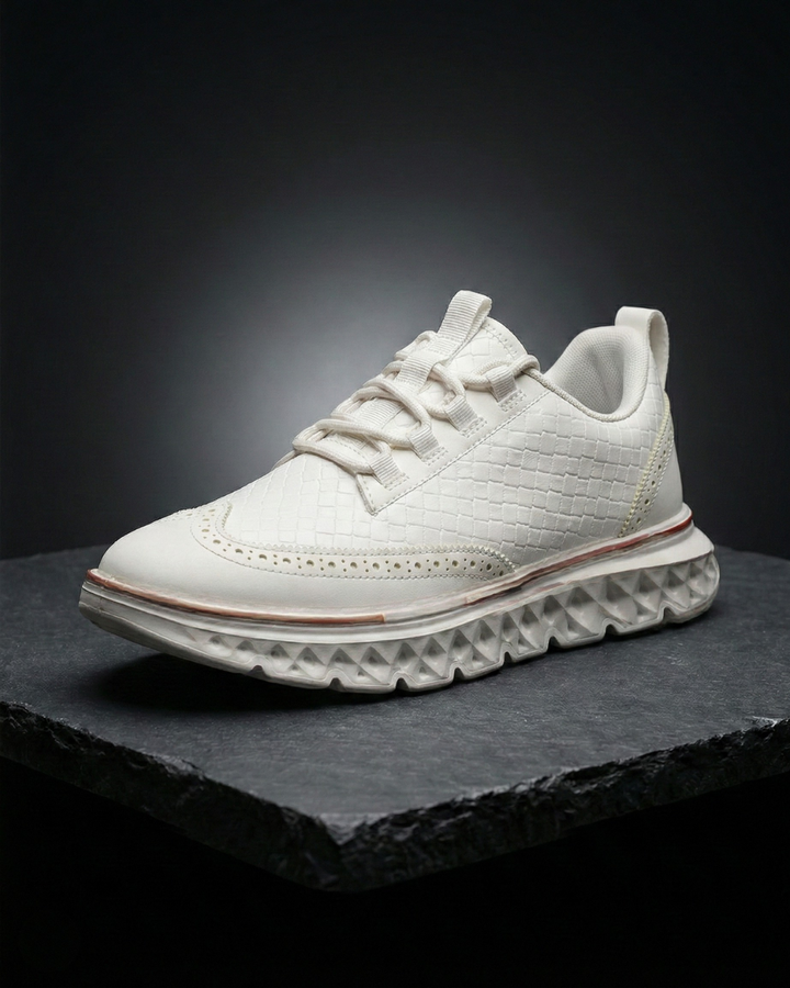 White dress sneaker with woven texture, lace-up front, and thick white tread sole