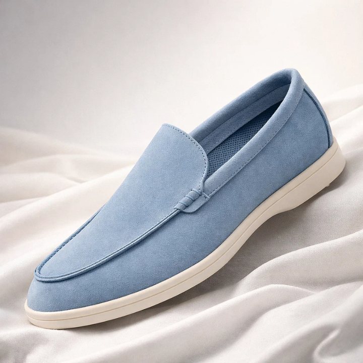 Blue suede loafer with stitched penny collar and low-profile white rubber sole