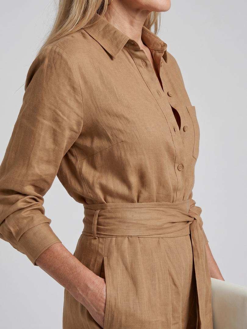 Brown tie-waist jumpsuit with button-front, collared neckline, long sleeves