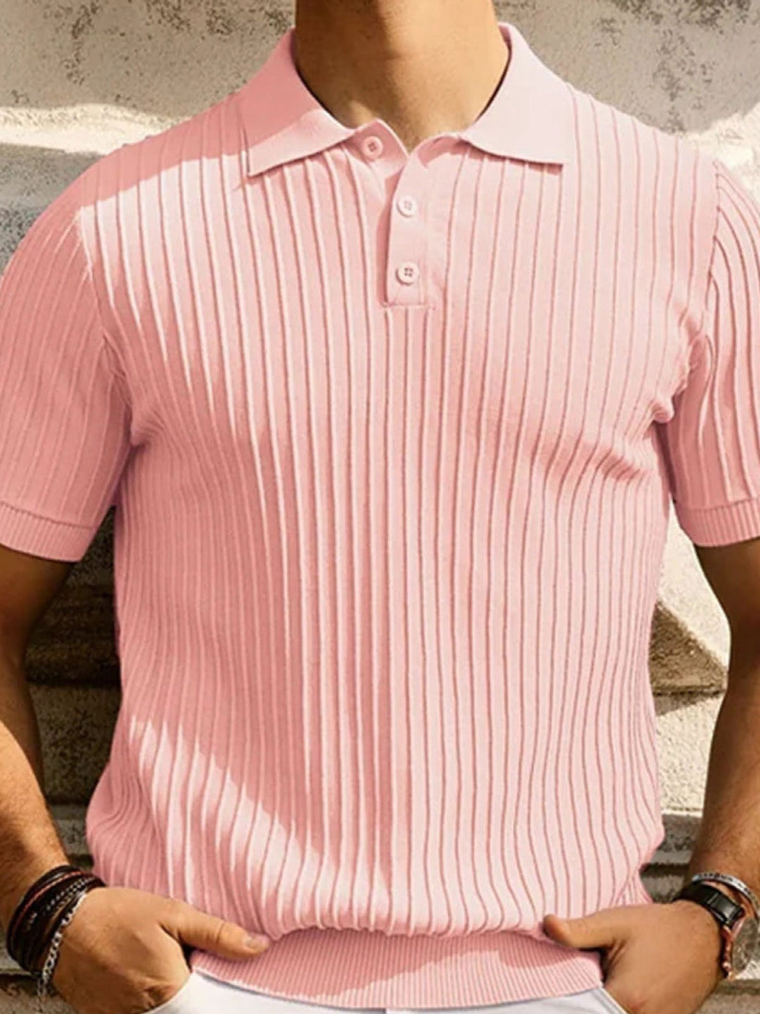 Pink rib-knit polo shirt on model, showing collar and button placket detail