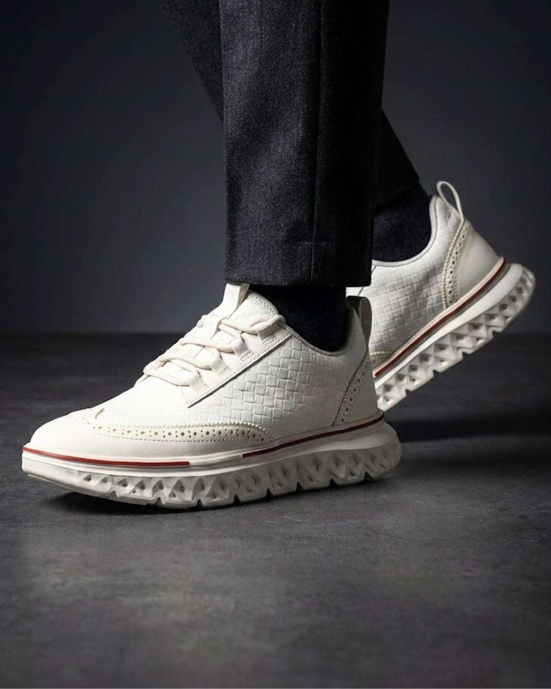 White dress sneaker with lace-up eyelets and textured tread sole