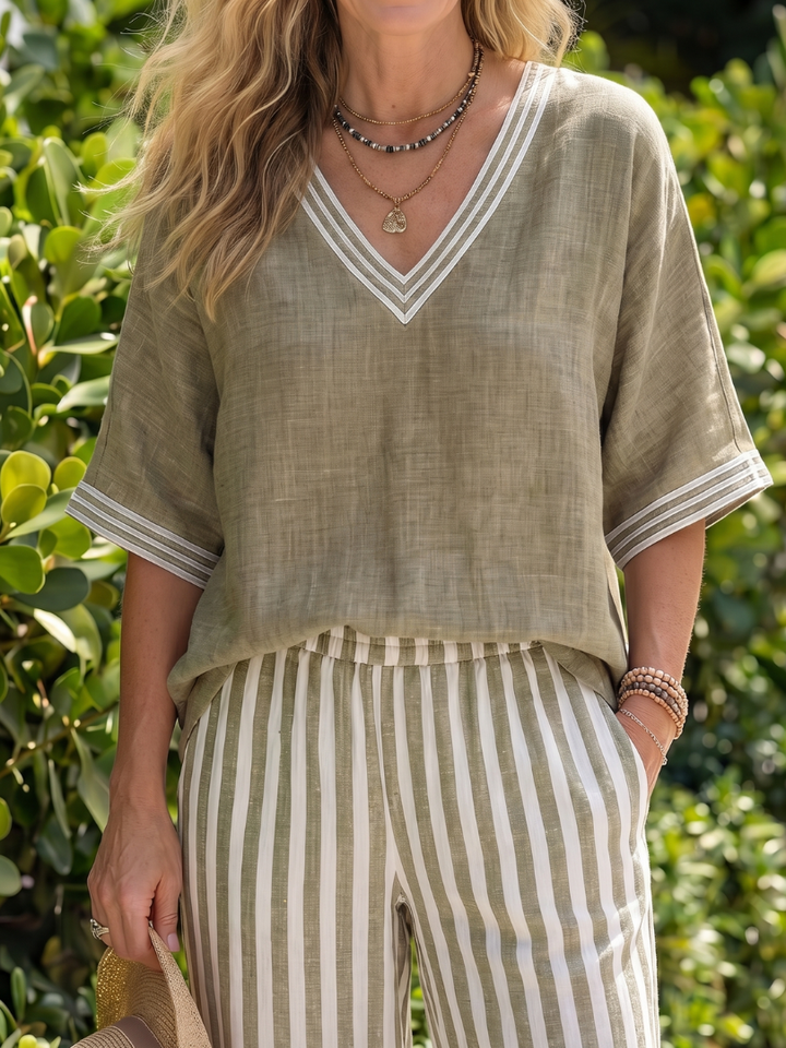 Sage V-neck blouse with white trim and matching vertically striped wide-leg pants