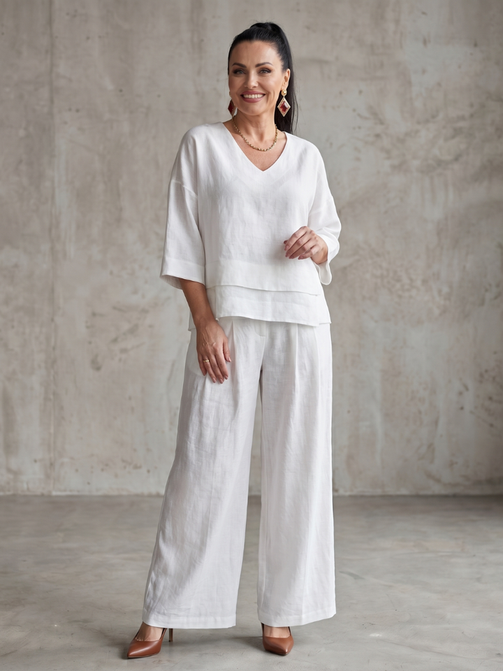 White two-piece wide-leg pants set with V-neck top and wide-leg trousers