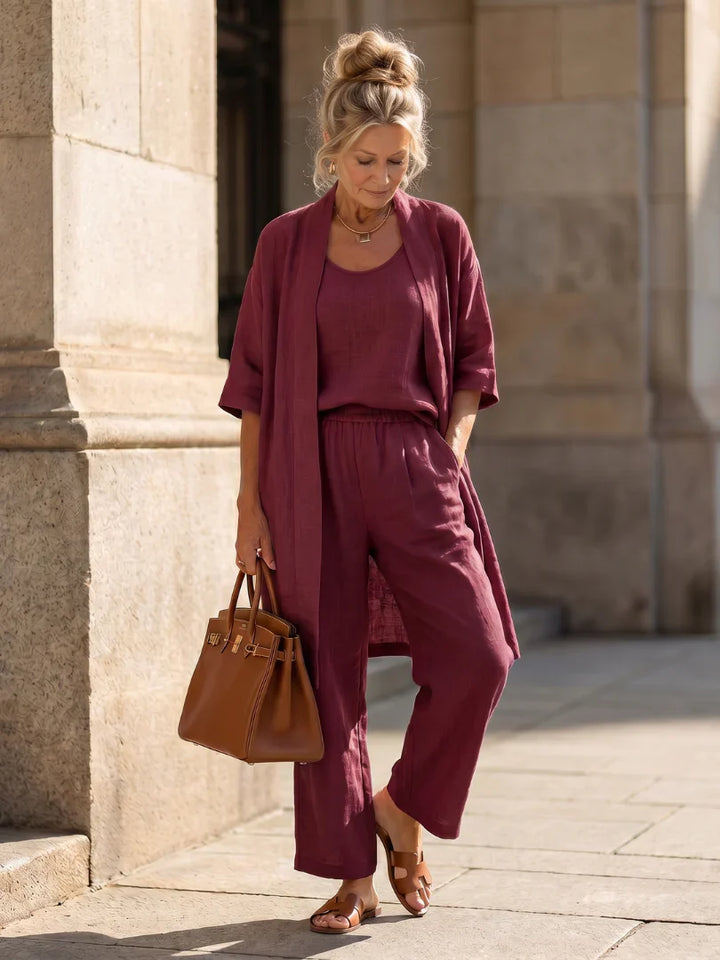 Women’s lounge set in wine red: open cardigan, camisole top, and wide-leg pants.