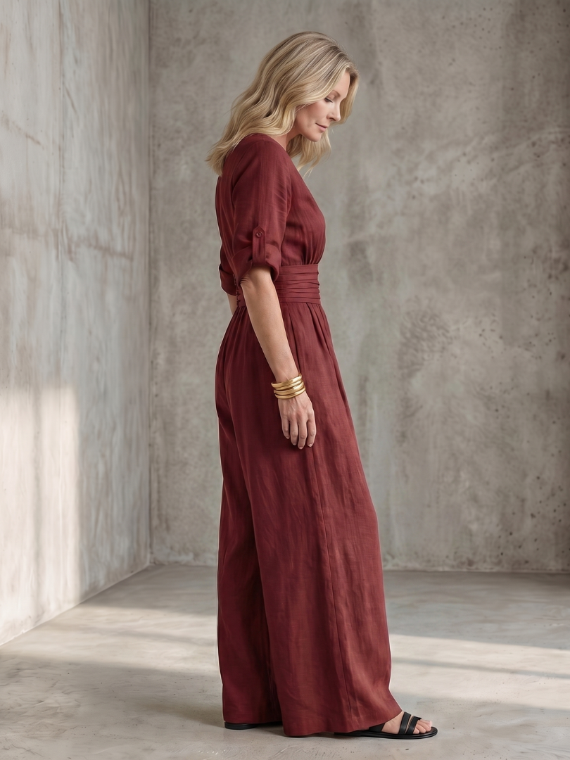 Burgundy wide-leg wrap jumpsuit, side view with gathered waist