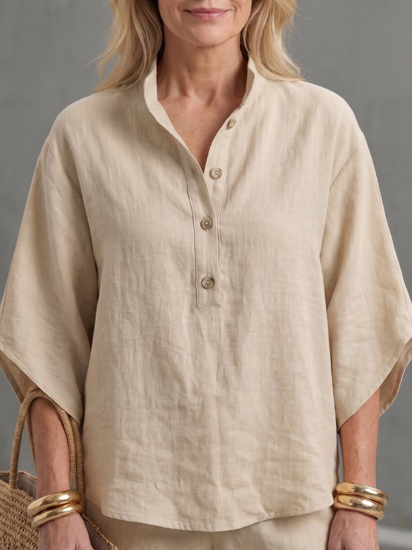 Beige button-up blouse with collared V neck and short sleeves