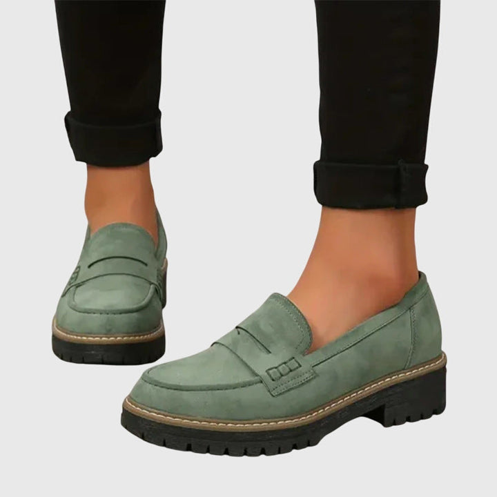 Green chunky slip-on loafers with strap detail and tan-edged thick tread sole