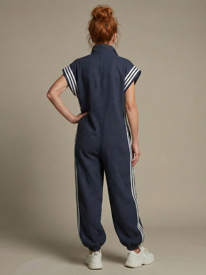 Back view blue sleeveless zip-front jumpsuit with striped shoulder panels