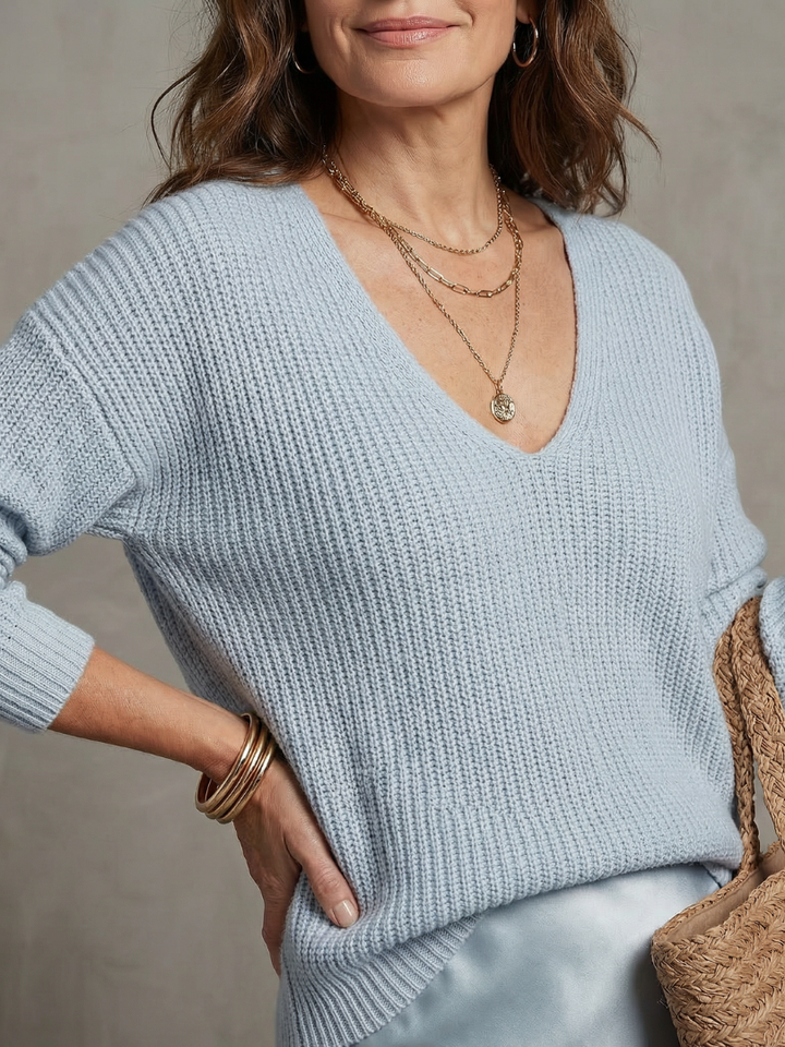 Light blue knit V-neck sweater with satin midi skirt at waist seam