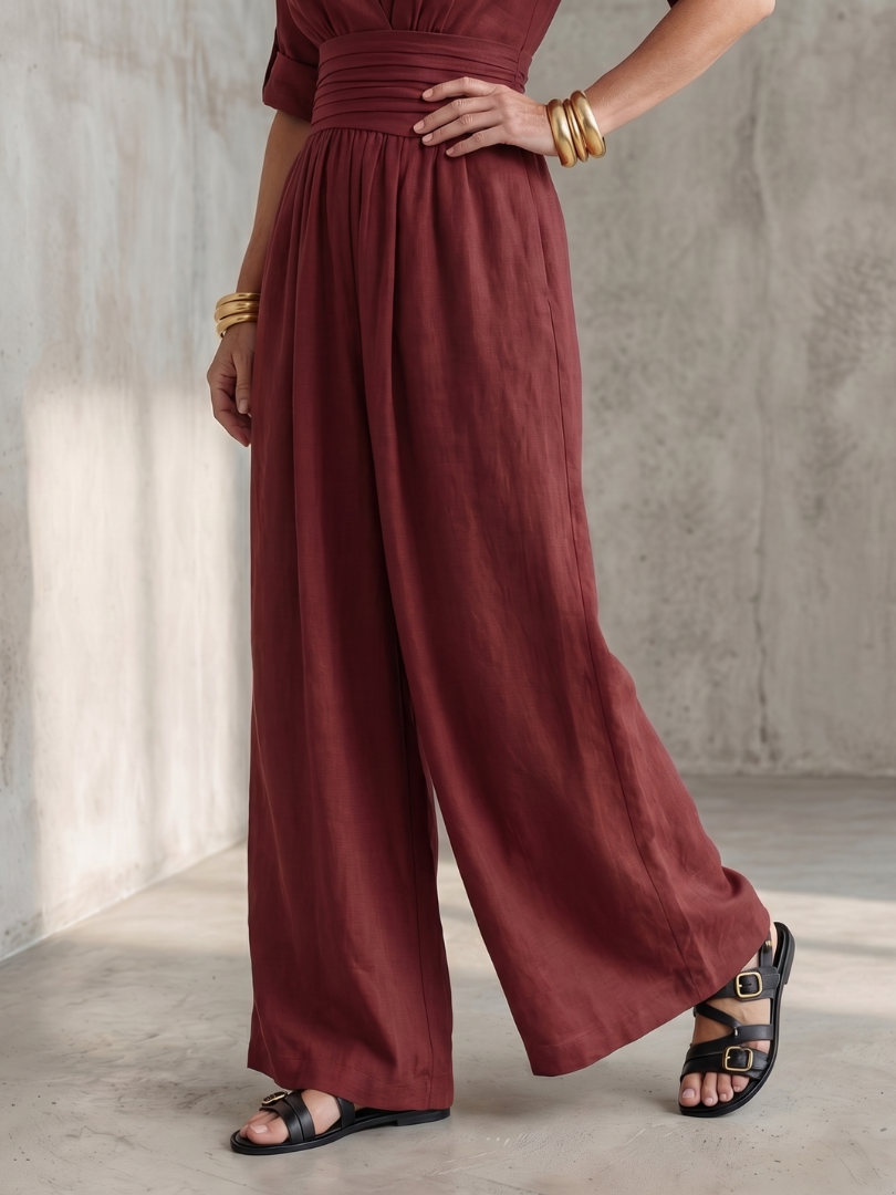 Burgundy wide-leg wrap jumpsuit with elastic waist and wide pant legs