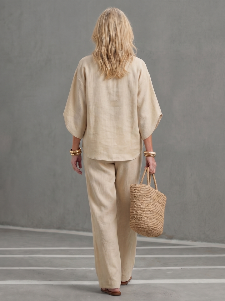 Beige two-piece set with button blouse and straight trousers, back view
