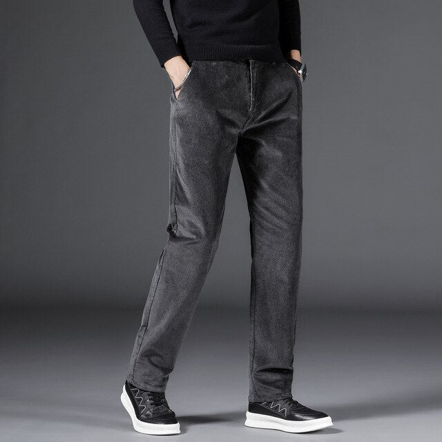 Medium-waist corduroy pants in dark gray with front pockets and subtle texture
