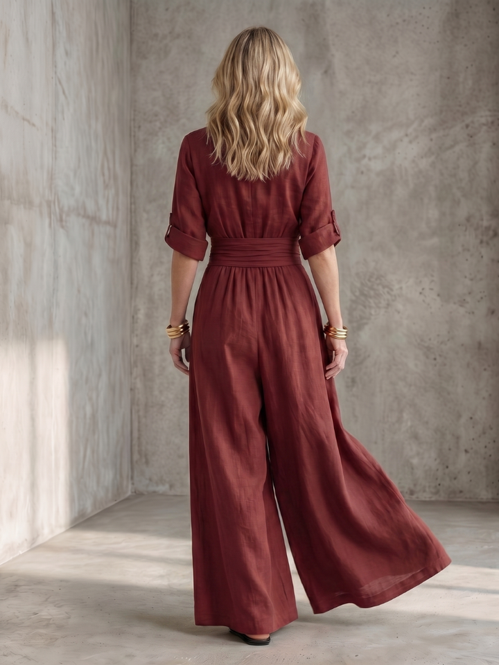 Burgundy wide-leg wrap jumpsuit, back view with tied waist