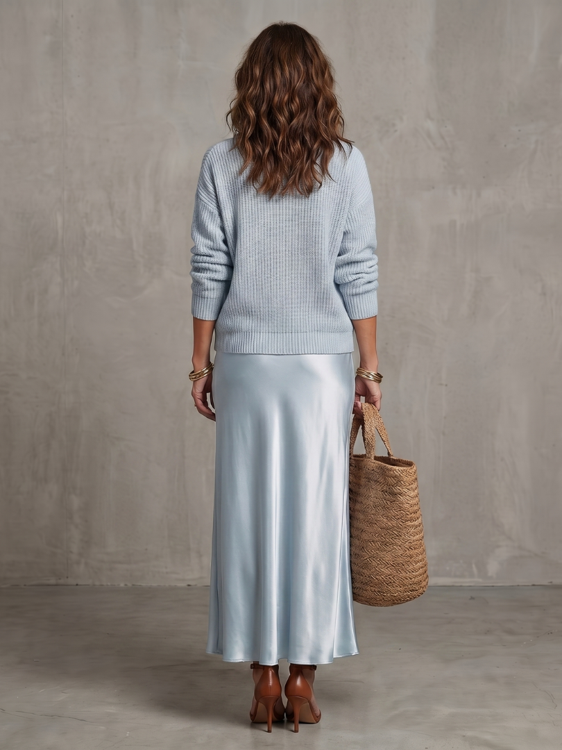 Light blue satin two-piece set, knit sweater and satin midi skirt from back