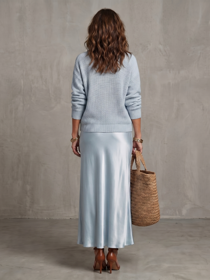 Light blue satin two-piece set, knit sweater and satin midi skirt from back
