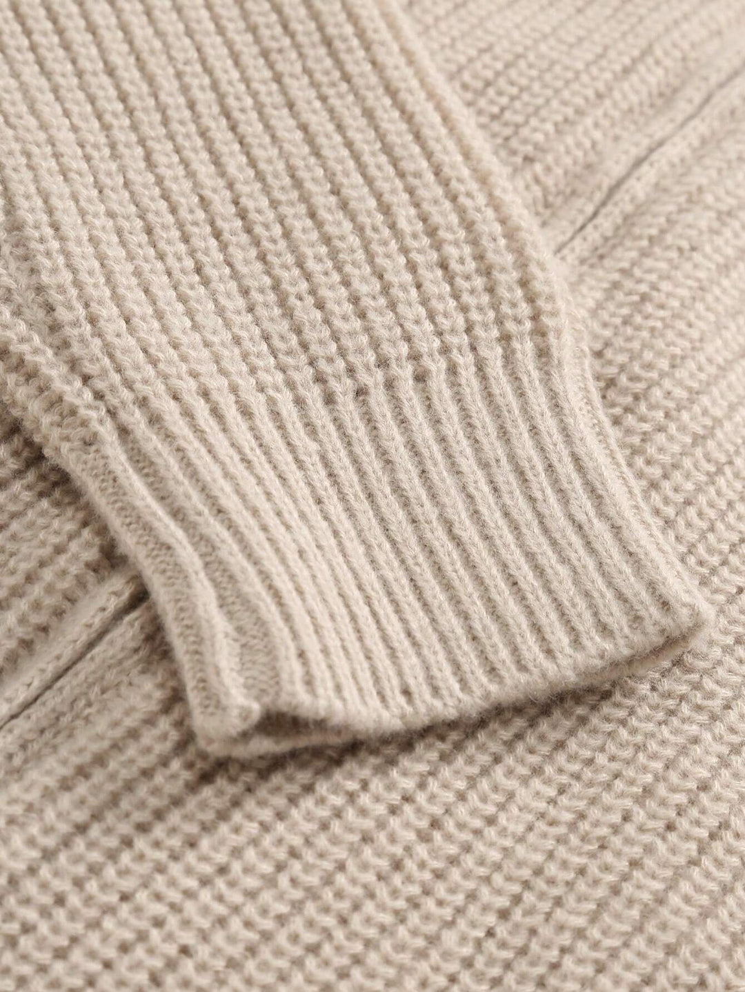 Beige knit zip placket and collar edge on cardigan