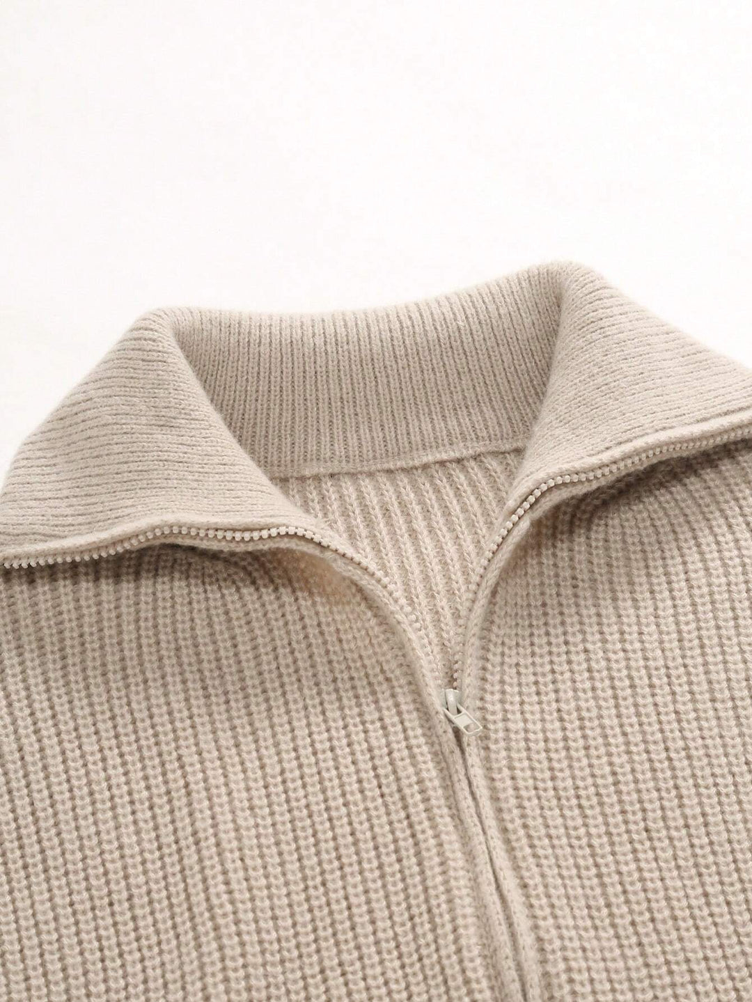Beige ribbed collar zip-up cardigan with visible zipper seam