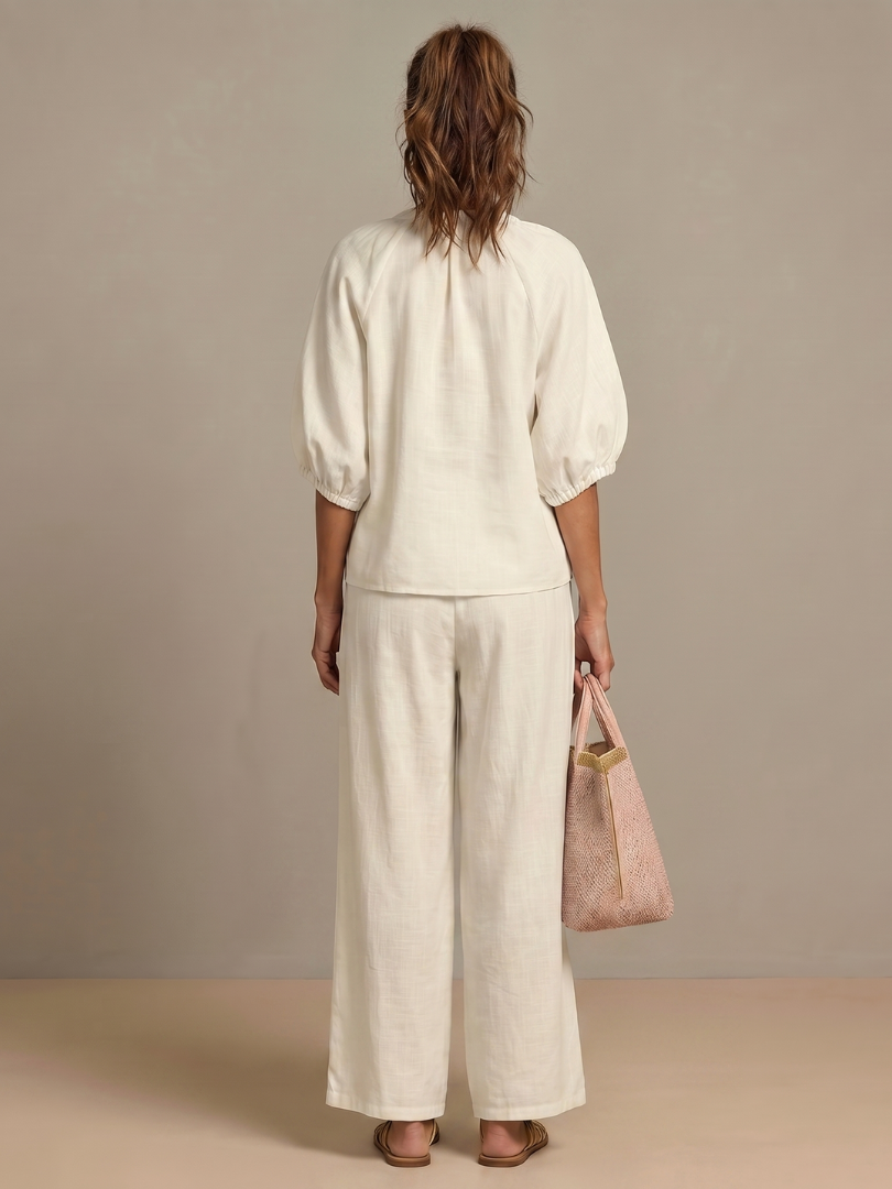 Women’s white 2-piece pants set, back view with puff sleeves and wide-leg trousers