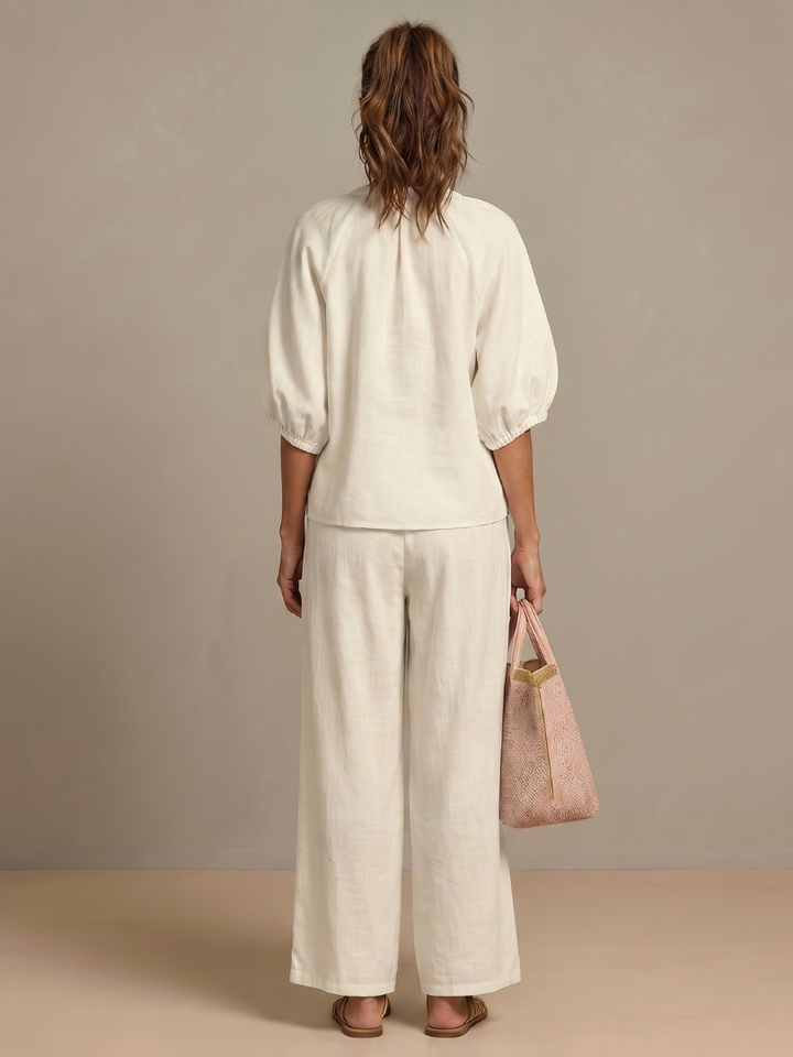 Women’s white 2-piece pants set, back view with puff sleeves and wide-leg trousers