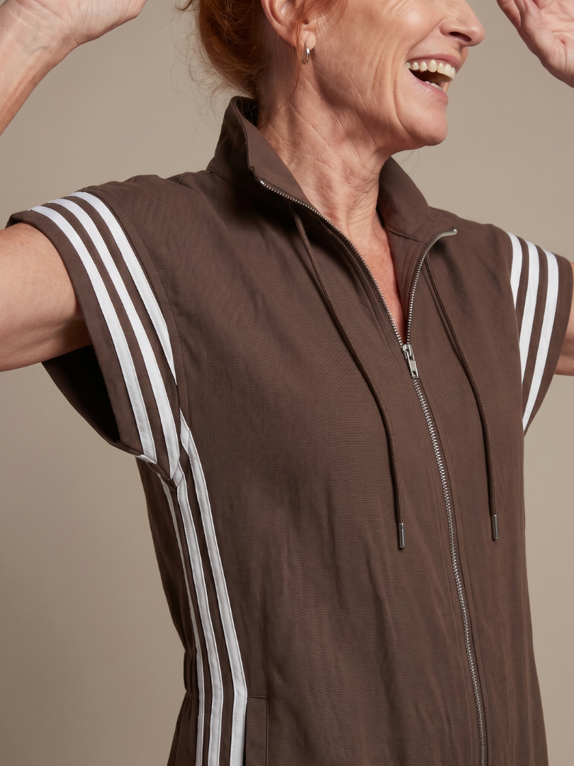 Brown sleeveless zip-front jumpsuit with white striped shoulder trim