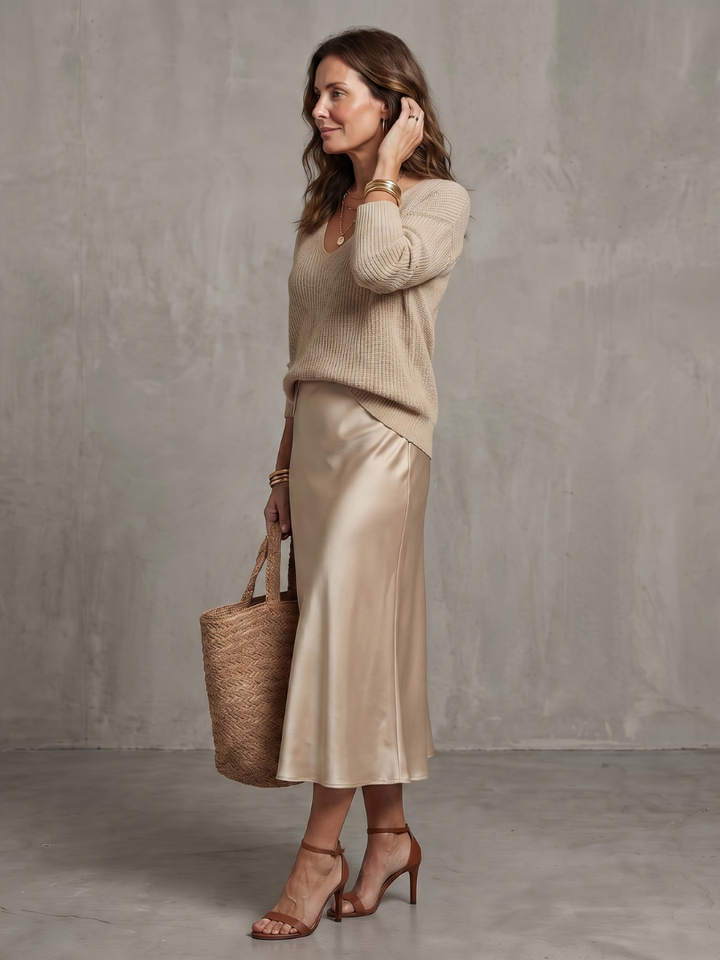 Beige satin two-piece set with knit V-neck sweater and satin midi skirt