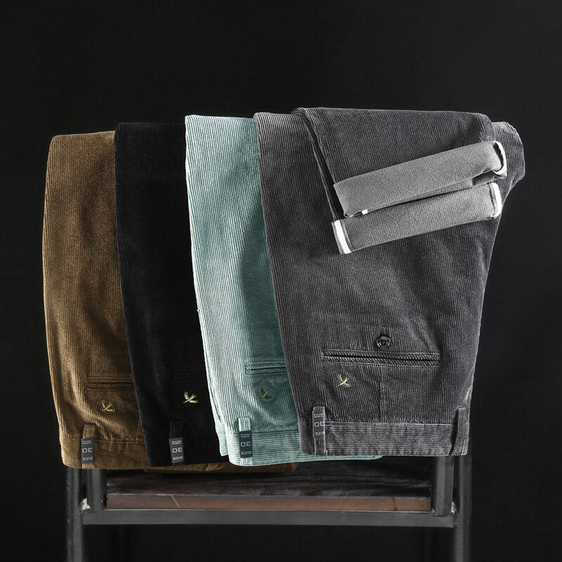 Folded corduroy pants assortment in brown, black, light blue, and gray