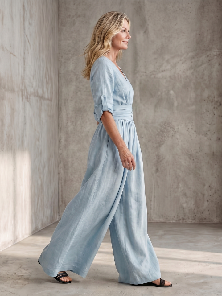 Sky blue wide-leg wrap jumpsuit, side view with gathered waist