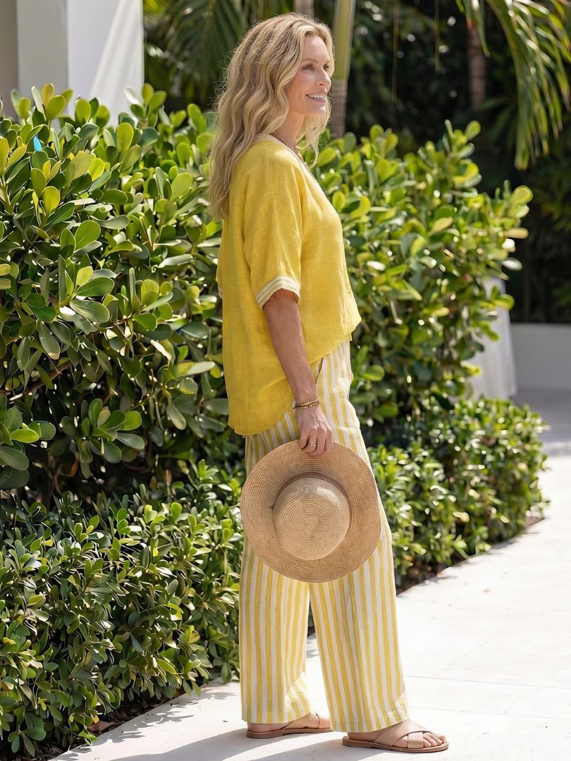 Yellow V-neck blouse and vertically striped wide-leg pants set, side view