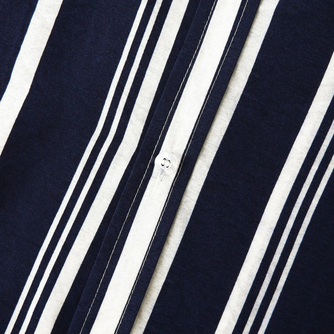 Navy blue striped shirt front placket with white vertical stripes and small buttons