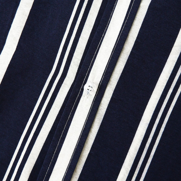Navy blue striped shirt front placket with white vertical stripes and small buttons