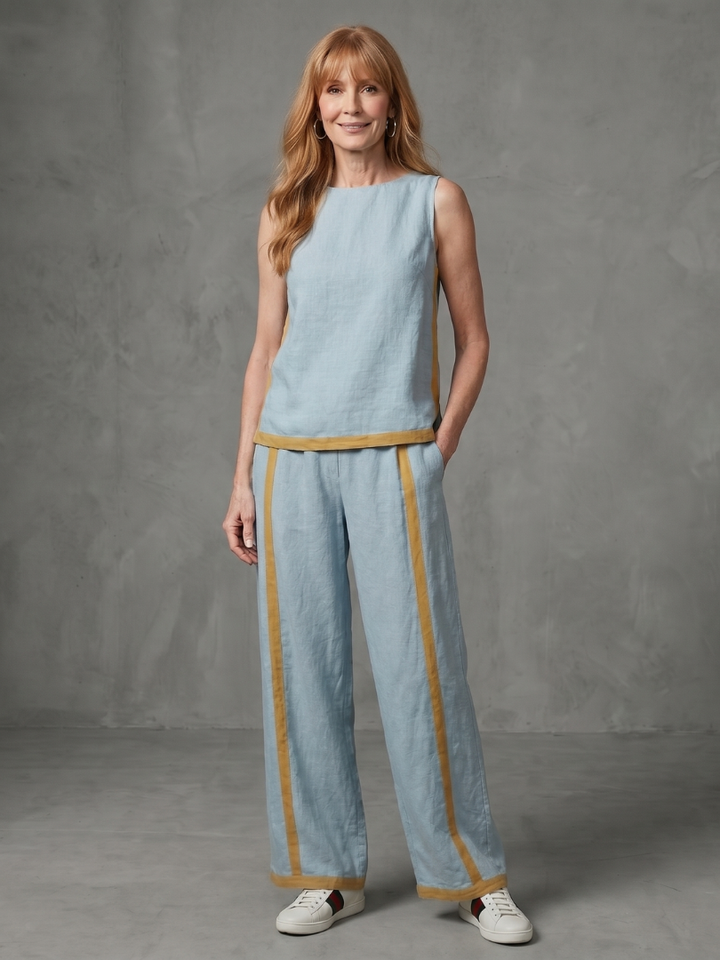 Sky blue linen set with sleeveless top and wide-leg pants, tan contrast trim