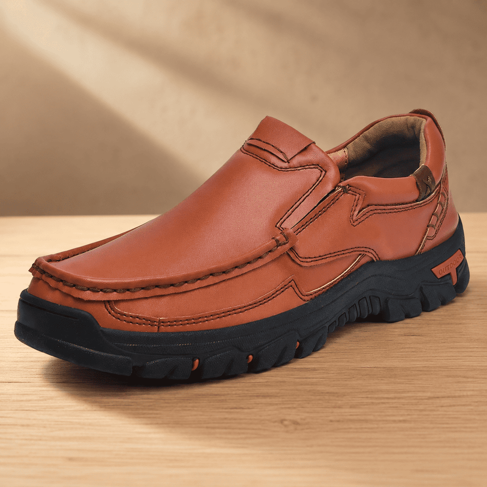 Brown slip-on loafer-style shoes with stitched seams, cushioned sole, and logo patch