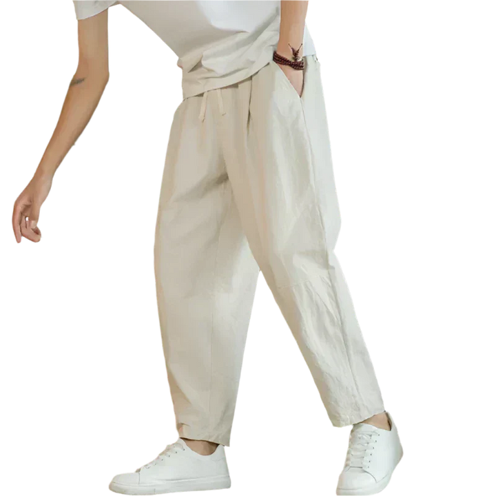 Beige cotton pants with drawstring waist, relaxed tapered leg, ankle length