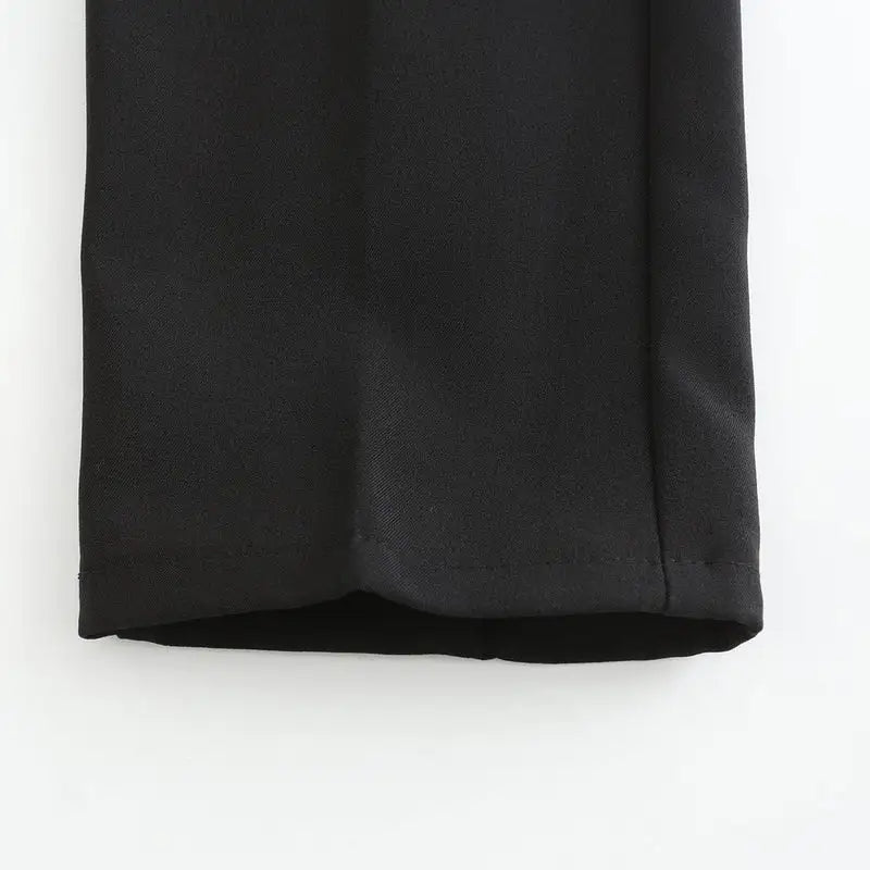 Black stretch pants fabric close-up with visible woven texture