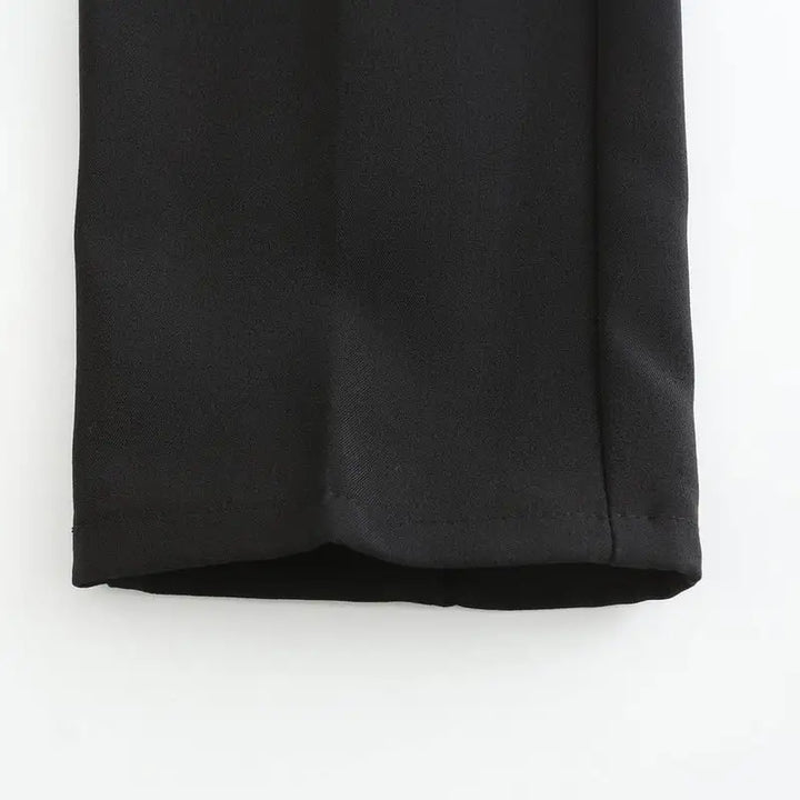 Black stretch pants fabric close-up with visible woven texture