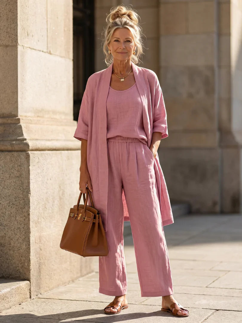 Pink women’s lounge set with short-sleeve top, drawstring pants, and open kimono robe layer