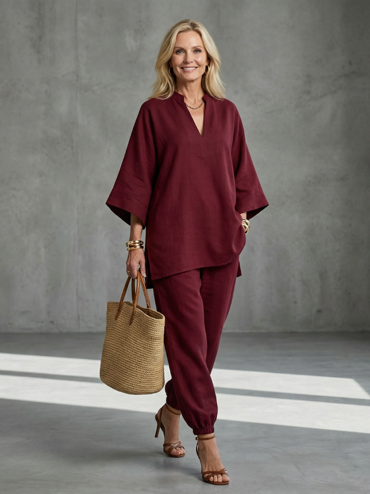 Burgundy women’s V-neck two-piece set with tunic top and relaxed ankle pants, side view