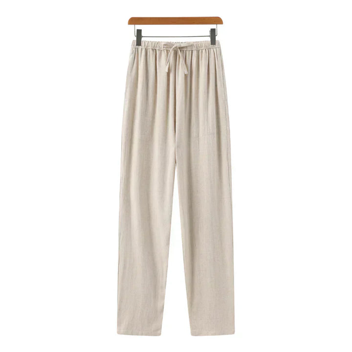 Beige linen pants with elastic waistband, drawstring, and relaxed straight legs.