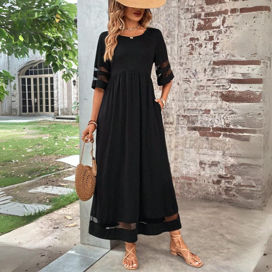 Black midi dress with gathered waist, sheer cutout sleeves, and mesh hem panel.